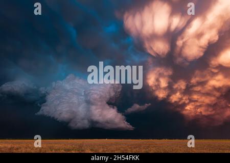 A dramatic, stormy sky at sunset with mammatus clouds over a field in Lubbock, Texas Stock Photo
