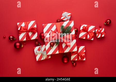 Christmas gift boxes and Christmas balls on red background Stock Photo