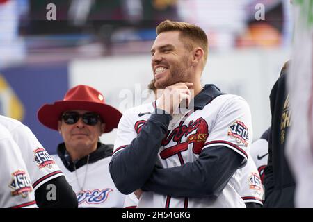 Atlanta Braves first baseman Freddie Freeman and New York Yankees  outfielder Aaron Judge share a laugh at first base with Freeman giving him  a pat on the shoulder after Judge hit a