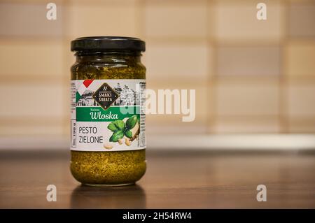 POZNAN, POLAND - Nov 26, 2017: An Italian green pesto in a glass jar on a table Stock Photo