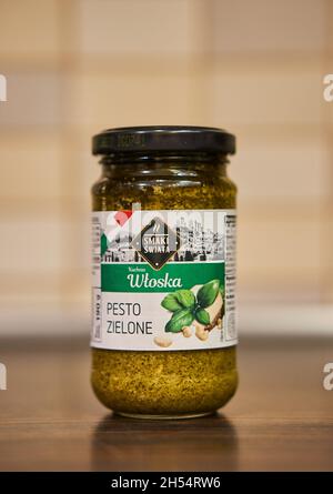 POZNAN, POLAND - Nov 26, 2017: An Italian green pesto in a glass jar on a table Stock Photo