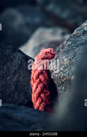 A red rope that was washed up ashore at the danish north sea coast. High quality photo Stock Photo