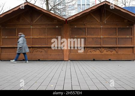 Duisburg, Germany. 06th Nov, 2021. A woman walks past still closed stalls of the Christmas market in the pedestrian zone in the city centre. (to dpa 'Ahead of the opening of numerous Christmas markets in the coming week') Credit: Fabian Strauch/dpa/Alamy Live News Stock Photo