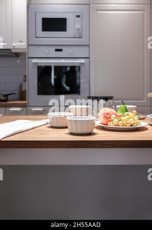 Part of the kitchen interior with utensils and fruits on the table. Stock Photo