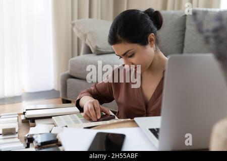Indian female architect or interior designer choosing tiles samples Stock Photo