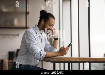 Happy young african american man using cellphone. Stock Photo