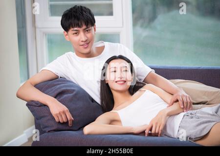 Young couple relaxing on the sofa Stock Photo