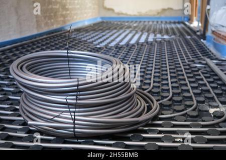 Underfloor heating system pipes on insulation. Radiant floor. Stock Photo