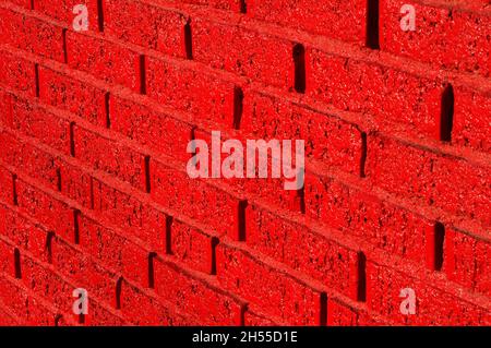 A red-painted brick wall. Stock Photo