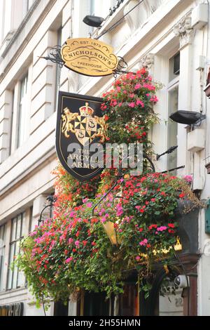 Logo and flower baskets above The Argyll Arms at Oxford Circus, London, UK Stock Photo