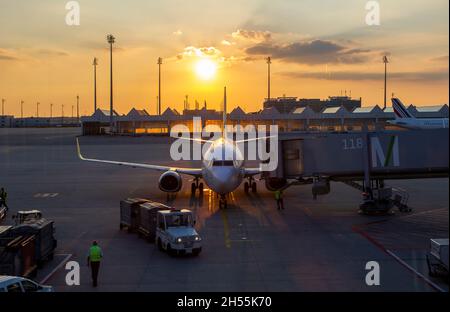 A munich, germany - 26 september 2016. Munich-Franz Josef Strauss International Airport. image of the airport at sunset. a plane is seen preparing for Stock Photo