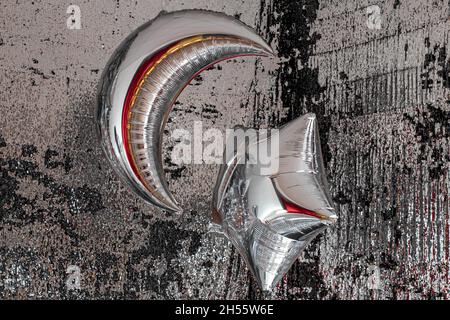 Silver balloons in the shape of the moon and stars. Stock Photo