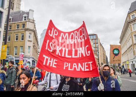 London, UK. 6th November 2021. Protesters march with a 'JP Morgan Is Killing The Planet' banner in the City of London. Thousands of people marched from the Bank of England to Trafalgar Square as part of the COP26 Coalition Global Day of Action For Climate Justice. Stock Photo