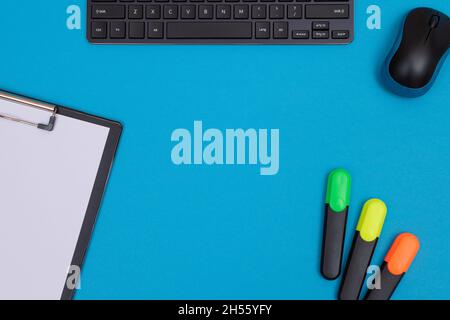 Office Workplace with Digital Gadgets Lying on Blue Table - Flat Lay Stock Photo