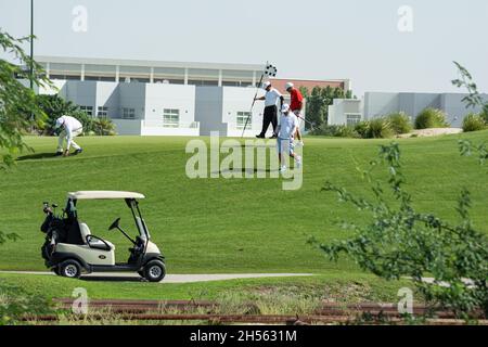 people playing golf and golf cart Stock Photo