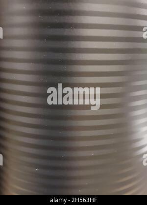 Metallic surface in matte black, smooth, with horizontal lines. full screen Stock Photo