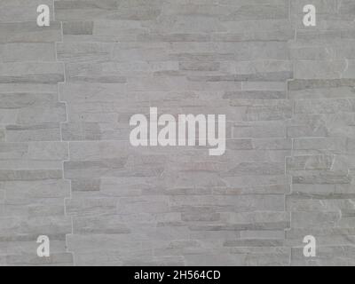 Interior wall surface with stone texture, grey, rustic, modern . Background and texture. Full screen. Stock Photo