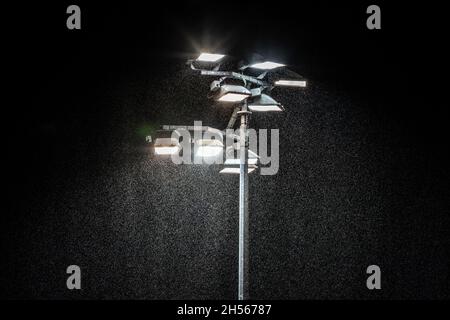 Stadium lights in the rain at the British Final at the National Speedway Stadium, Manchester, 16 August 2021 Stock Photo