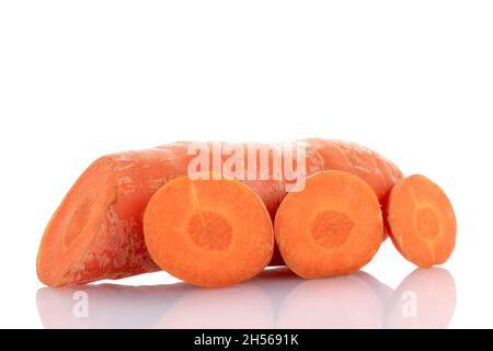 One fresh organic, unpeeled carrot cut into slices, close-up, isolated on white. Stock Photo