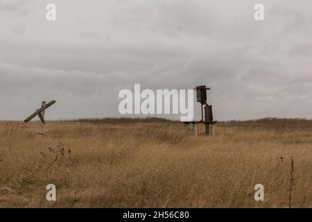 an old transformer without wires is in the field. Stock Photo