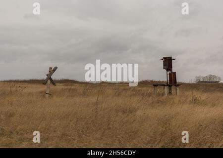 an old transformer without wires is in the field. Stock Photo
