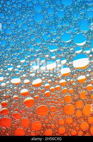 Blue and orange bubbles background. Foam bubbles macro texture. Stock Photo