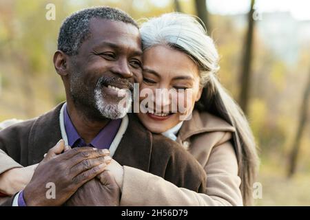 Storytelling image of a multiethnic senior couple in love Stock Photo
