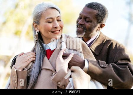 Storytelling image of a multiethnic senior couple in love Stock Photo