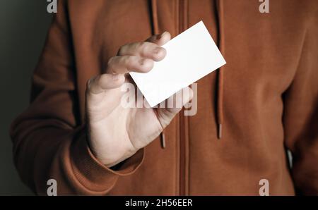 Man's hand showing blank white business card. Man holding business card. Stock Photo