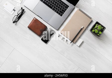 Business office supplies and laptop on wooden background. Copy space for text. Flat lay. Stock Photo