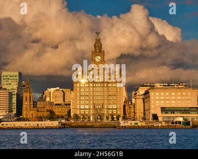 The Royal Liver Building, one of the Three Graces on the historic Liverpool waterfront on the River Mersey - taken with the setting sun reflecting in Stock Photo