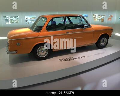 BMW 2002 TI, side view, orange color. The BMW 02 Series is a range of compact executive cars produced by BMW from 1966 to 1977. BMW Museum. Stock Photo