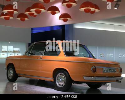 BMW 2002 TI, side view, orange color. The BMW 02 Series is a range of compact executive cars produced by BMW from 1966 to 1977. BMW Museum. Stock Photo