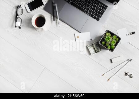 Mix of office supplies and gadgets on wooden background. Copy space for your text. Flat lay. Stock Photo