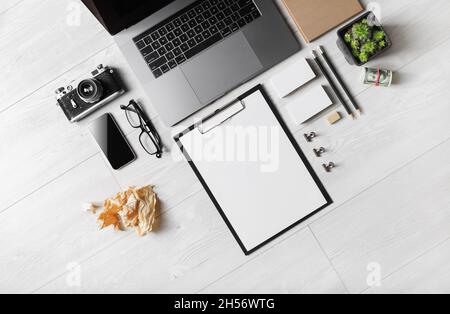 Blank stationery and gadgets on wooden background. Flat lay. Stock Photo