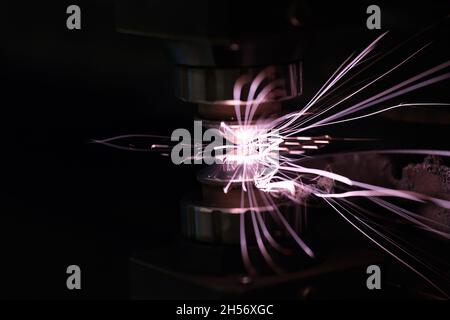 Sparks from metal on a dark background, close-up Stock Photo