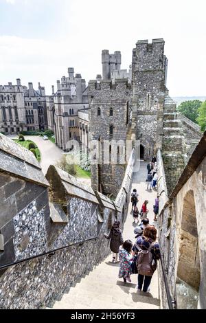 Tourists walking down the stairs leading down from the Keep at Arundel Castle, West Sussex, UK Stock Photo