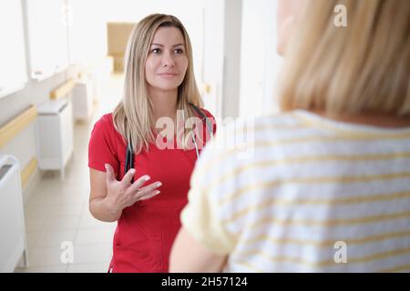Woman medical specialist speaks with a patient Stock Photo