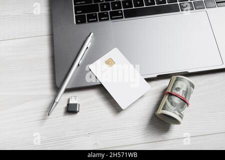 Online business concept. Money, blank credit card, pen, flash drive and laptop keyboard. Stock Photo