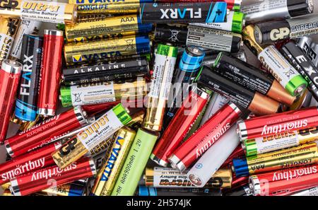 MOSCOW, RUSSIA - November 6, 2021: Abstract background from used AAA batteries from different companies. Close up. Stock Photo