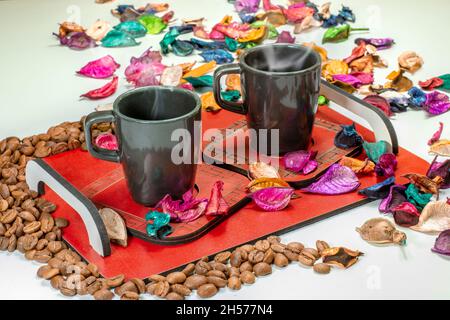 coffee cups and grains on tray on white table Stock Photo