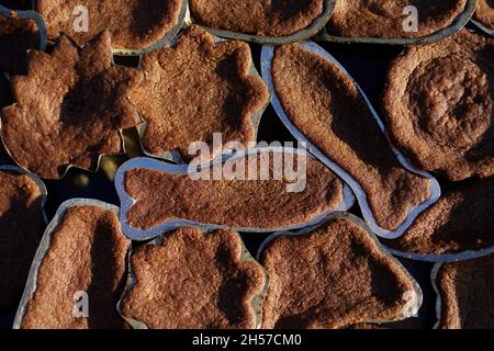 High angle view on baking tray with Christmas cocoa cookies in forms. Stock Photo