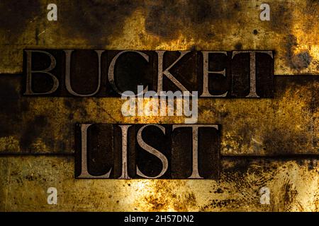Bucket List text message on textured grunge copper and vintage gold background Stock Photo