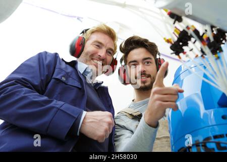 two electrician workers at cabling Stock Photo