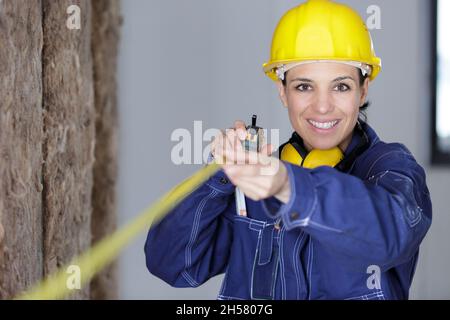 woman worker using measuring tape Stock Photo