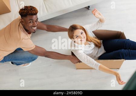 overjoyed couple  smiling playful with wife in cardboard box Stock Photo
