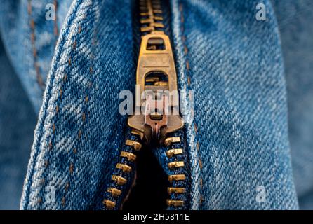 Closeup of zipper in blue jeans. Zipper with lock. A piece of denim Stock Photo