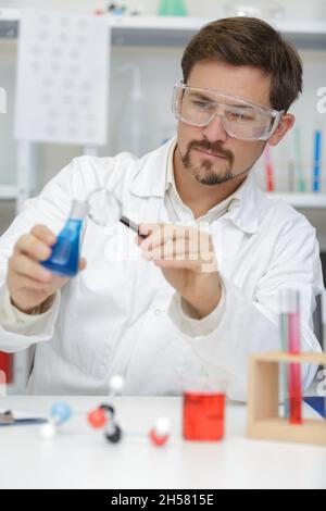 man checking liquids in the lab Stock Photo