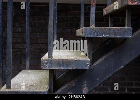 Outdoor Staircase, Steps, Stairs, Rusting Metal, Brick Wall in Background Stock Photo