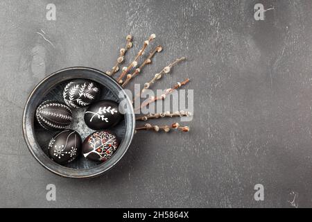 Black monochrome Easter greeting card with handmade wax dyed pysanka eggs in a bowl Stock Photo